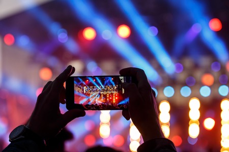 Video and photo recording of the concert by smartphone. Color music.の写真素材