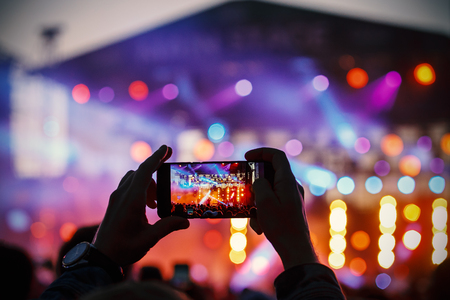 Video and photo recording of the concert by smartphone. Color music.の写真素材