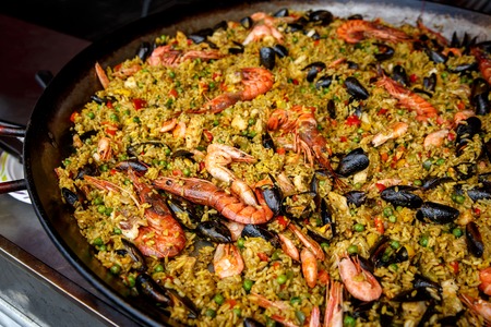 Mediterranean food. Seafood paella with rice, tomato sauce, langoustine, mussels squid shrimpの写真素材