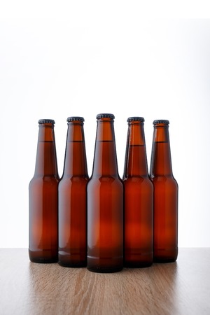 A row of beer bottles on white background. Five objectsの写真素材