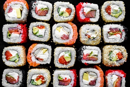 Traditional Japanese food - sush rolls on black background. Top viewの写真素材
