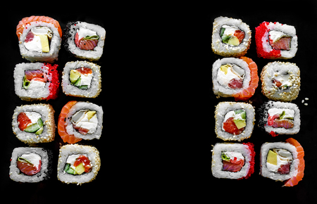 Traditional Japanese food - sush rolls on black background. Top view. With space for textの写真素材