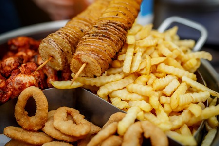 Beer snacks which consists of French fries, grilled chicken wings, potato chipsの写真素材