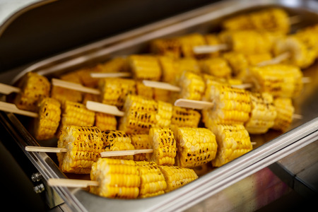 A lot of Fried Corn roast on a stick. Close-up Street food. Top viewの写真素材