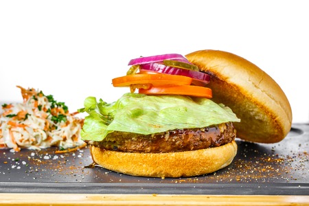 Tasty burger with beef cutlet on white background. Highlighted ingredientsの写真素材