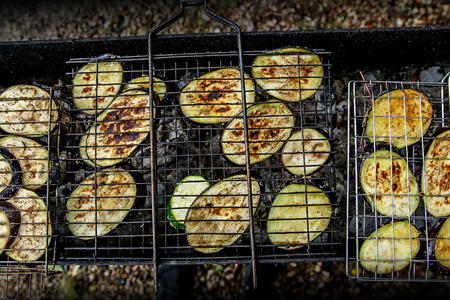 Grilled zucchini cooking on an open flame grillの写真素材