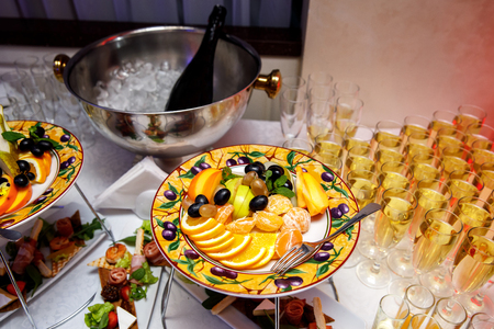 Fruits and glasses with champagne on the table before the event. Top viewの写真素材