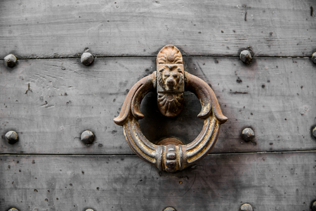 Old heavy door knob with decorative lion, Wooden doorの写真素材