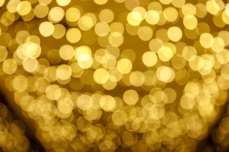 Abstract blur yellow sparkle bokeh background. Blurred defocused lights in yellow colors. Blurred Bokeh. Christmas light background.の写真素材