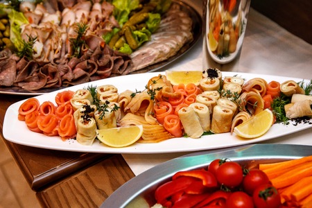 Beautifully decorated catering banquet table with different food snacks and appetizers on corporate, christmas, birthday, party, event or wedding celebrationの写真素材