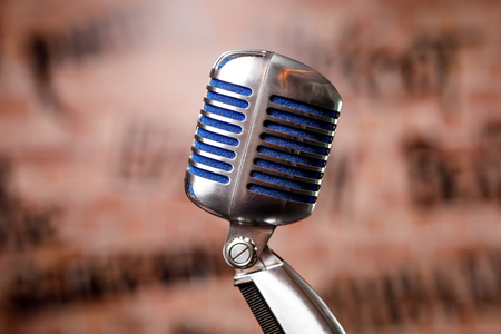 Retro microphone on stage in a pub or bar, restaurant during a night show.の写真素材