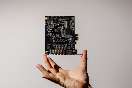 PCI Express card for computer in hand, 7.1 audio chipの写真素材