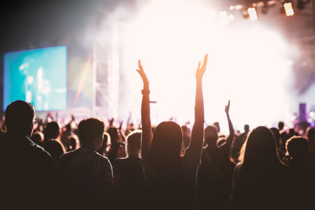 hands of happy people crowd having fun at stage at summer live rock festival