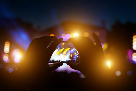 Hands with a smartphone record live music festival, live concert, live concert.の写真素材