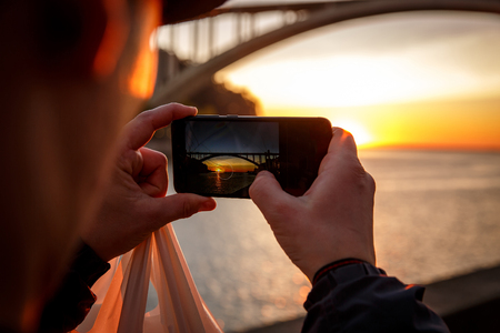 Shoots a bridge at sunset on a smartphoneの写真素材
