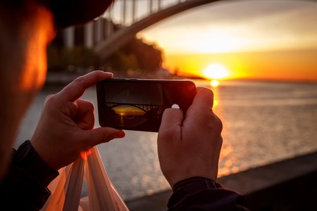 Shoots a bridge at sunset on a smartphoneの写真素材