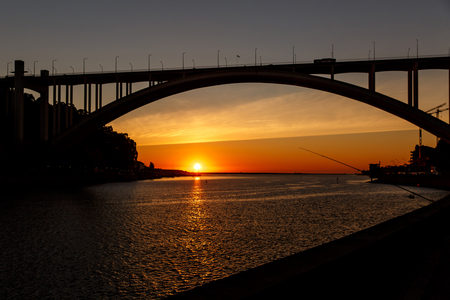 Silhouette of a bridge over the river at sunset. Porto, Portugalの写真素材