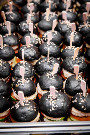 A lot of mini black burgers on event cateringの写真素材