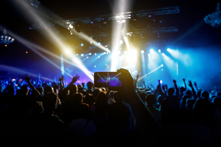 Photo for social networks at the concert, Mobile phone on music showの写真素材