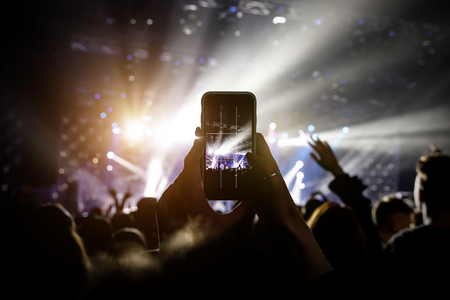 Photo for social networks at the concert, Mobile phone on music showの写真素材