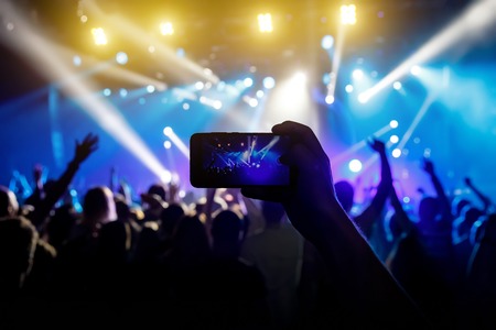 Photo for social networks at the concert, Mobile phone on music showの写真素材