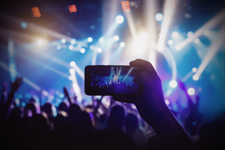Photo for social networks at the concert, Mobile phone on music showの写真素材