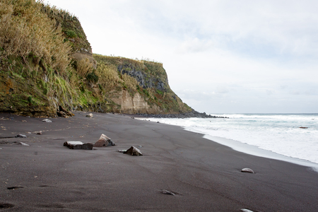 Black sand beach on a volcanic islandの写真素材