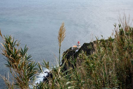 Old lighthouse on the shore.の写真素材