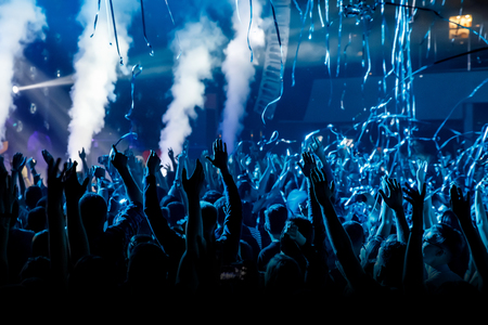 Crowd with raised hands on music concert.の写真素材