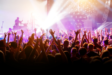Crowd with raised hands on music concert.の写真素材
