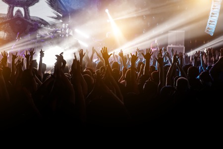 Crowd with raised hands on music concert.の写真素材