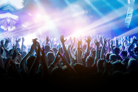 Crowd with raised hands on music concert.の写真素材
