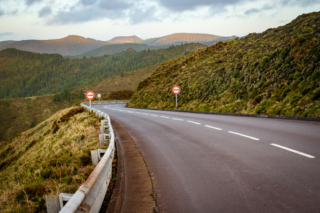 Empty road in the mountains. Sunset. No overtaking signの写真素材