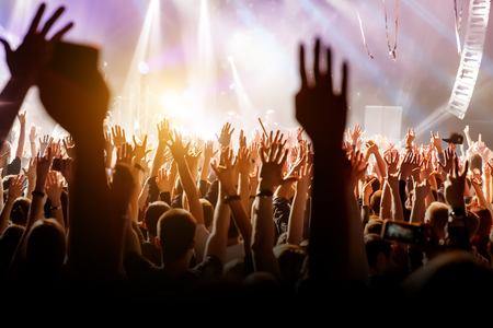 Crowd with raised hands on music concert.の写真素材