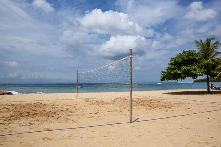Beach volleyball court. Sand and mesh on oceanの写真素材
