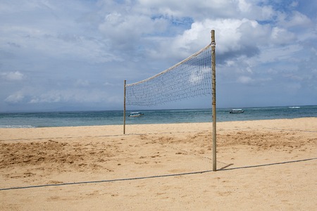 Beach volleyball court. Sand and mesh on oceanの写真素材