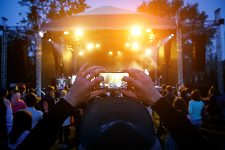 Hands with a smartphone records live music festival, Taking photo of concert stageの写真素材