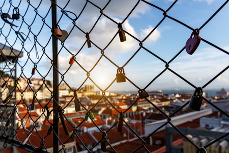 Locks on the cage, Old city on a blurredの写真素材