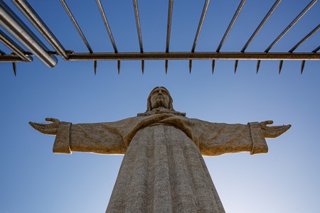 Statue of Christ in front of the iron fence, concept of struggle against religionの写真素材