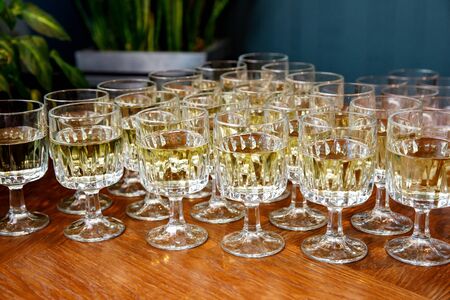 Glasses with wine on a banquet tableの写真素材