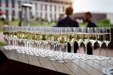 Beautiful row of filled wine glasses at an event.の写真素材