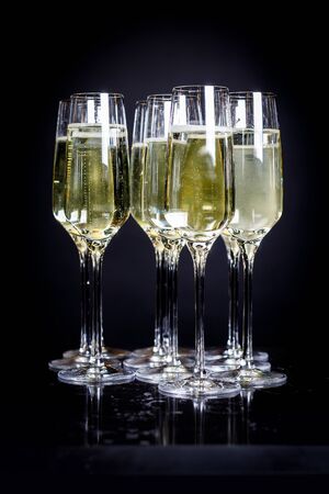 A lot of wine glasses with a cool delicious champagne or white wine at the bar or event catering. Alcohol background.の写真素材