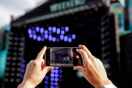 Video recording on a mobile phone, concert showの写真素材