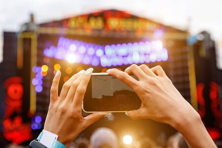 Recording a concert on a mobile phone, Outdoor stageの写真素材
