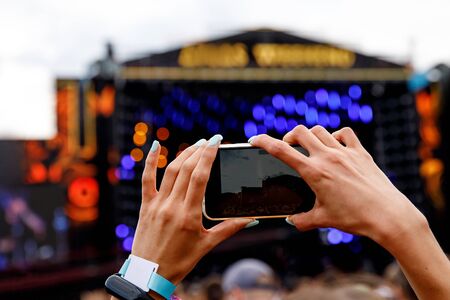 Recording a concert on a mobile phone, Outdoor stageの写真素材