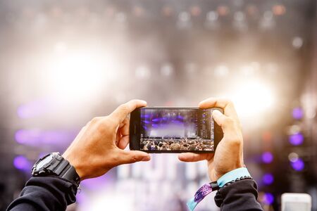 Recording a concert on a mobile phone, Outdoor stageの写真素材