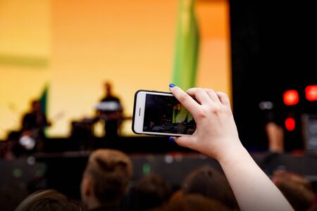 Video recording on a mobile phone, concert showの写真素材