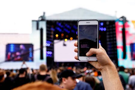 Video recording on a mobile phone, concert showの写真素材