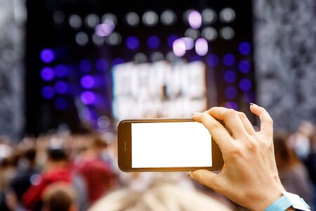 Recording outdoor music concert on a mobile phone. Blank screenの写真素材