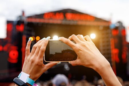 Recording a concert on a mobile phone, Outdoor stageの写真素材